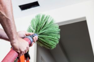 A man holding a cleaning brush